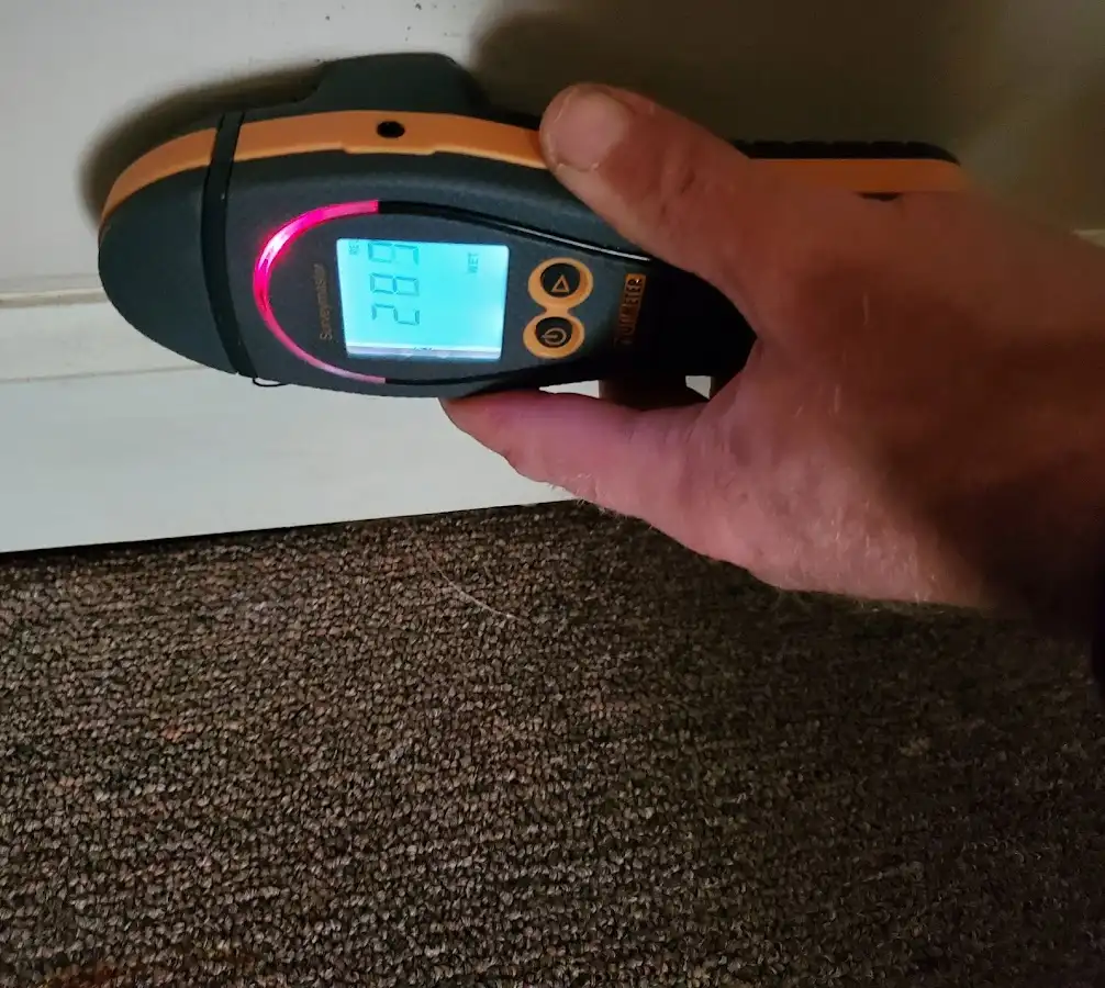 Moisture detection at baseboard during Storm Damage Restoration in Brookings